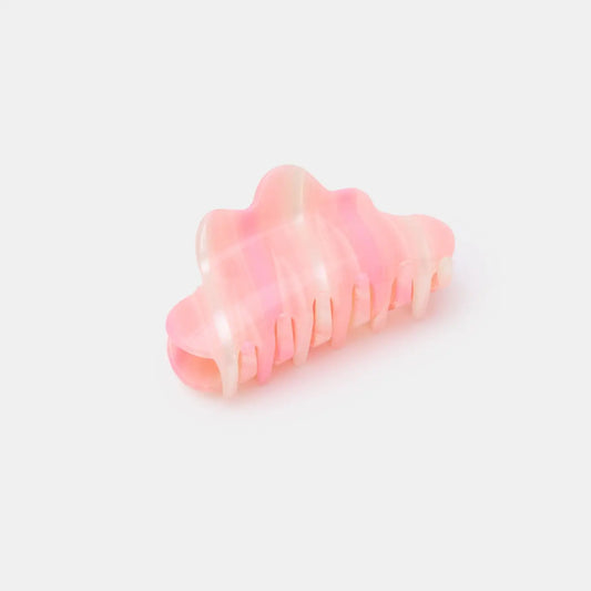 Pink hair clip on a light pink background