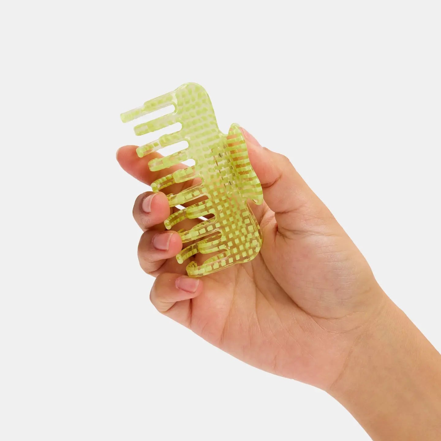 Hand holding a green clip against a white background