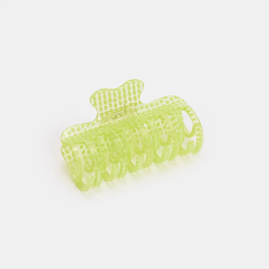 Green hair clip on a white background