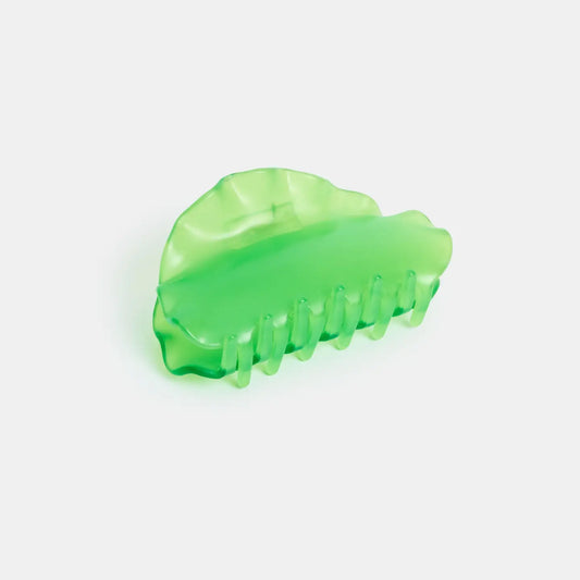 Green hair clip on a white background
