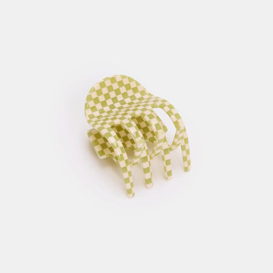 Green and white checkered hair clip on a light gray background